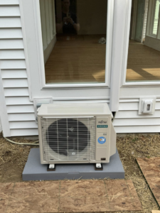 An outdoor Fujitsu Airstage mini-split condenser unit installed on a concrete pad by Vai Services in Wilmington, DE.