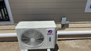An outdoor mini-split HVAC condenser unit installed next to a residential building by Service Kings Heating and Air in Jamestown, ND.