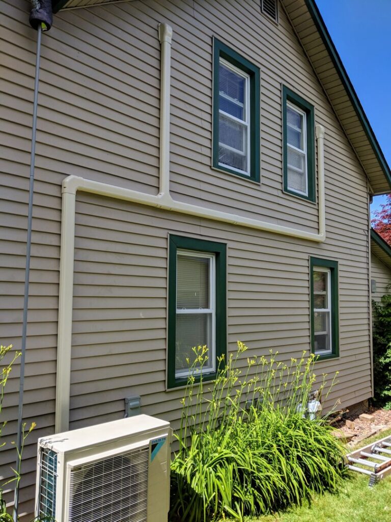 An outdoor mini-split condenser unit installed by Total Comfort Heat and Air Conditioning, Inc. in Rochester, NY.