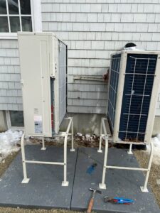 Two outdoor mini-split condenser units installed on stands by Excel Mechanical and Construction LLC in Brunswick, ME