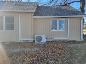 An outdoor mini-split condenser unit with line sets installed by Vega Heating and Cooling in Kansas City, KS
