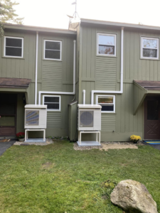 Two outdoor mini-split HVAC units installed on a building by ProTec in Bakersfield, CA.