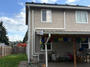 An outdoor mini-split unit with extensive line routing on the side of a house by DiMartino's 5 Star Heating & Air Conditioning LLC in Salem, OR.