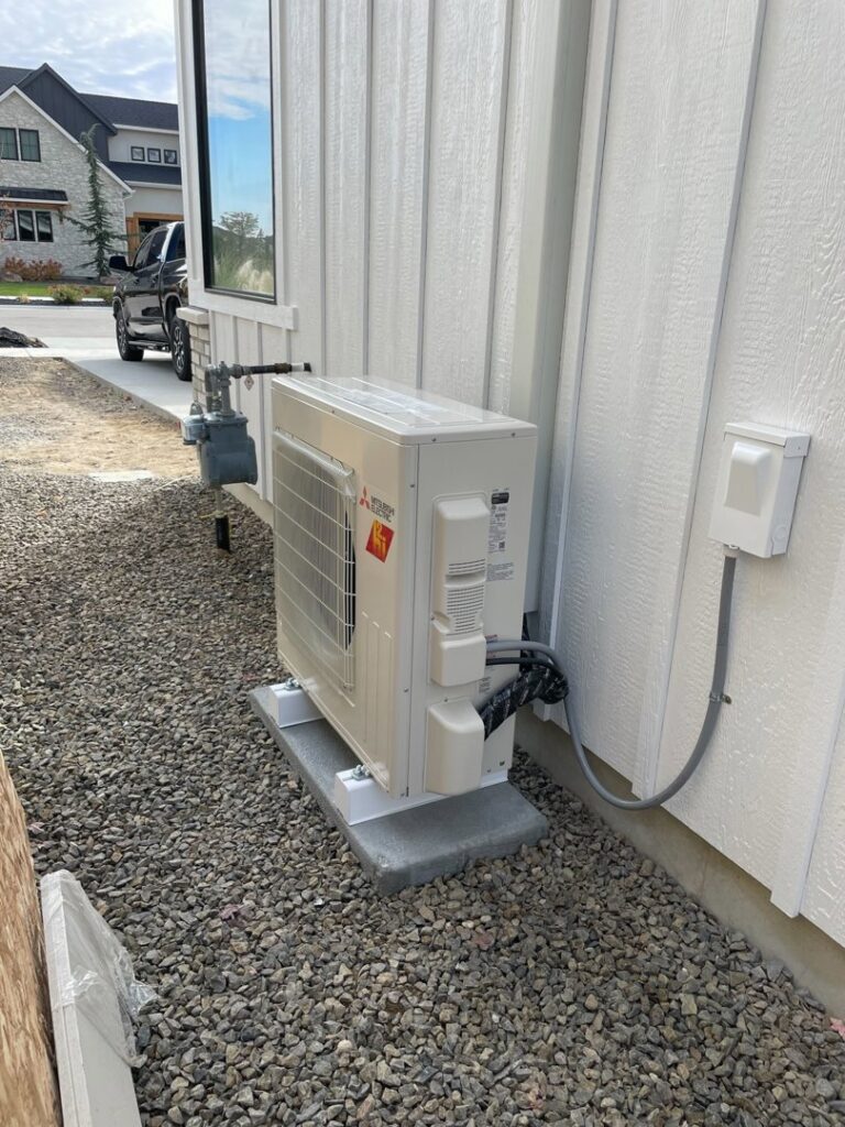 An outdoor mini-split HVAC unit newly installed next to a modern home by Boise Valley Heating & Air in Meridian, ID