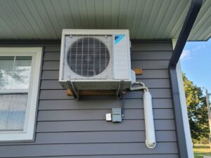 An outdoor mini-split HVAC unit professionally installed on the side of a residential home by Fusion Heat and Air in Fort Smith, AR.