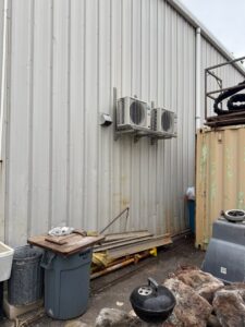 Two outdoor mini-split condenser units installed on a commercial building by Air Masters, Inc. in Port Orchard, WA.