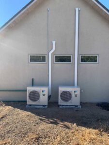 Two Daikin outdoor mini-split units installed next to a residential building by Jerome's Mechanical, LLC in Santa Fe, NM