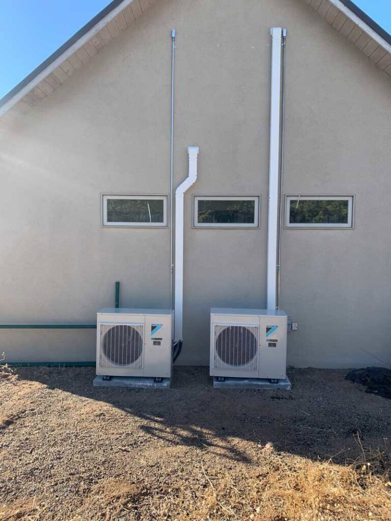 Two Daikin outdoor mini-split units installed next to a residential building by Jerome's Mechanical, LLC in Santa Fe, NM