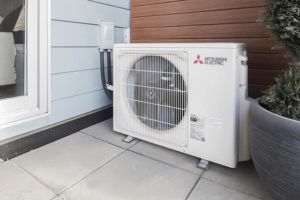 An outdoor Mitsubishi Electric HVAC condenser unit installed by Forever Mechanical INC. in Worcester, MA