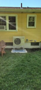 An outdoor Mitsubishi mini-split condenser unit installed by Hampden County HVAC Inc. in Indian Orchard, MA