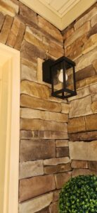 An outdoor motion sensor light and camera installed on a metal building by Goodie's Electrical Contractors LLC in Dothan, AL