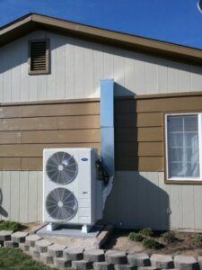 An outdoor multi-split air conditioning unit installed on the side of a house by Element Heating & Cooling, Inc. in Twin Falls, ID