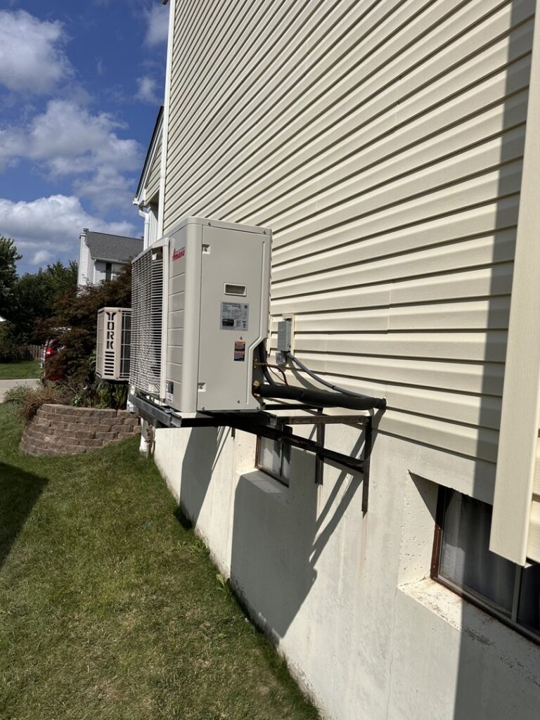 An outdoor multi-split HVAC system unit installed on a sturdy bracket by Integrity Aire in St. Charles, MO.