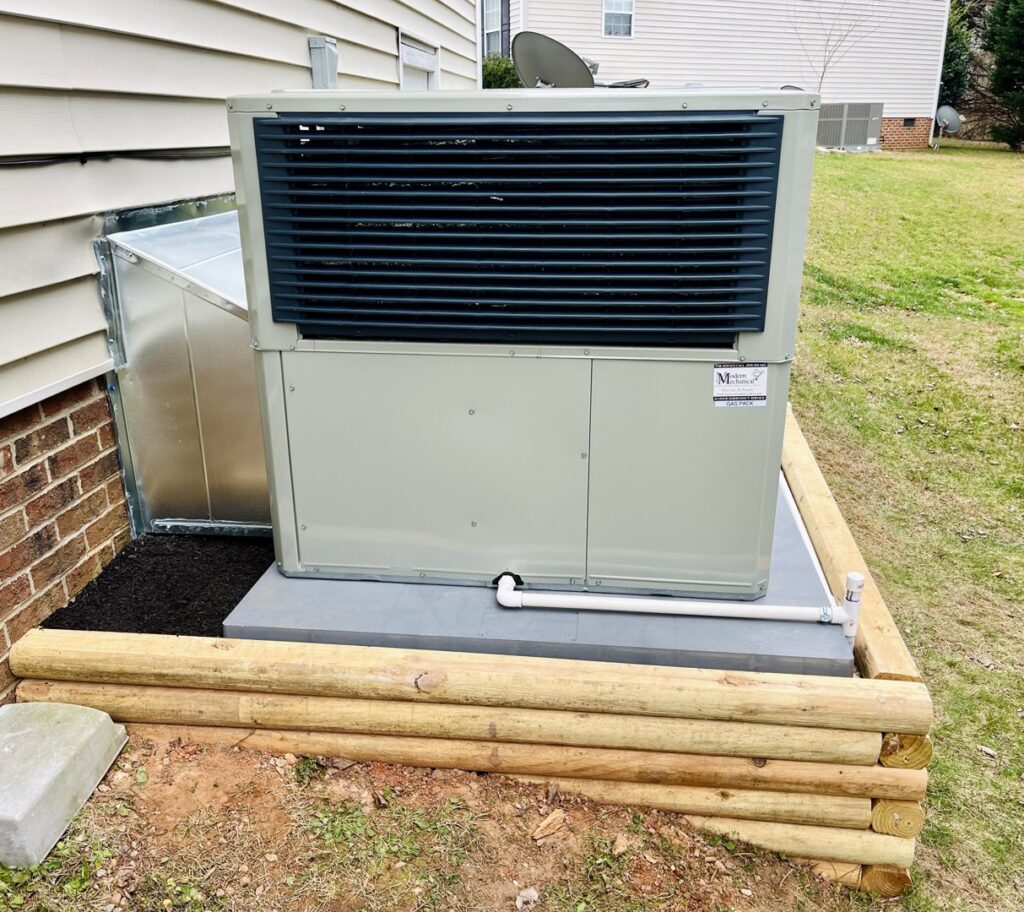 An outdoor packaged HVAC unit with new ductwork connection installed by Modern Mechanical HVAC in Garner, NC.