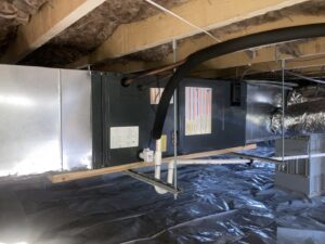 A newly installed outdoor packaged HVAC unit next to a residential building by Oakes AC Services, LLC in Louisburg, NC