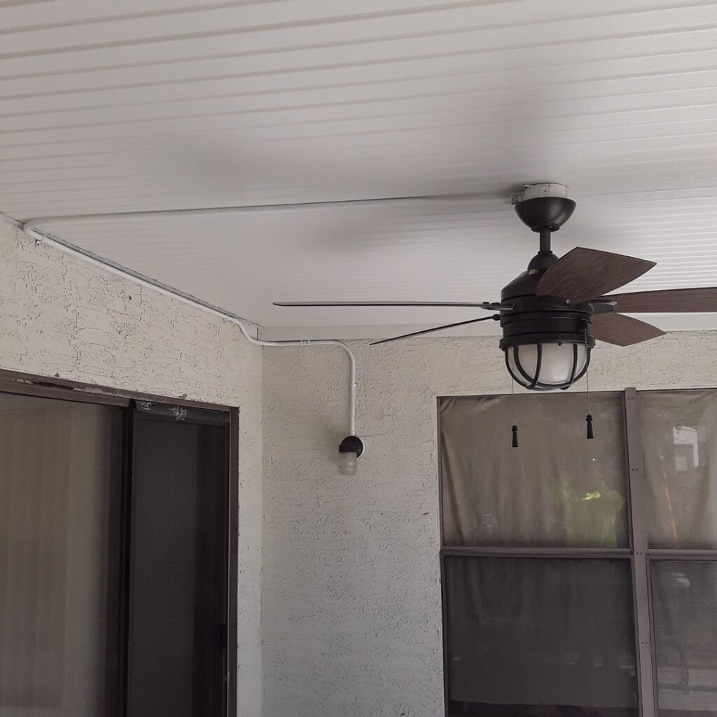 An outdoor patio with a newly installed ceiling fan and visible surface-mounted conduit wiring by GET LIT Electrical Services LLC in Glendale, AZ.