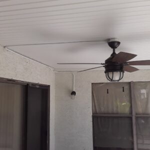 An outdoor patio with a newly installed ceiling fan and visible surface-mounted conduit wiring by GET LIT Electrical Services LLC in Glendale, AZ.