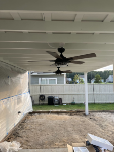 Two ceiling fans installed on an outdoor patio ceiling by Strother & Son Electric in Mount Pleasant, SC.