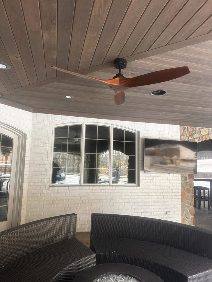 An outdoor patio with a modern ceiling fan and recessed lighting installed by Brian Jackson Electrical Service LLC in Sadler, TX