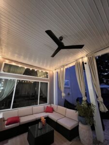 An outdoor patio featuring a newly installed ceiling fan and decorative string lights by V Electrical LLC in Albuquerque, NM.