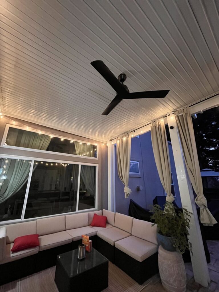 An outdoor patio featuring a newly installed ceiling fan and decorative string lights by V Electrical LLC in Albuquerque, NM.