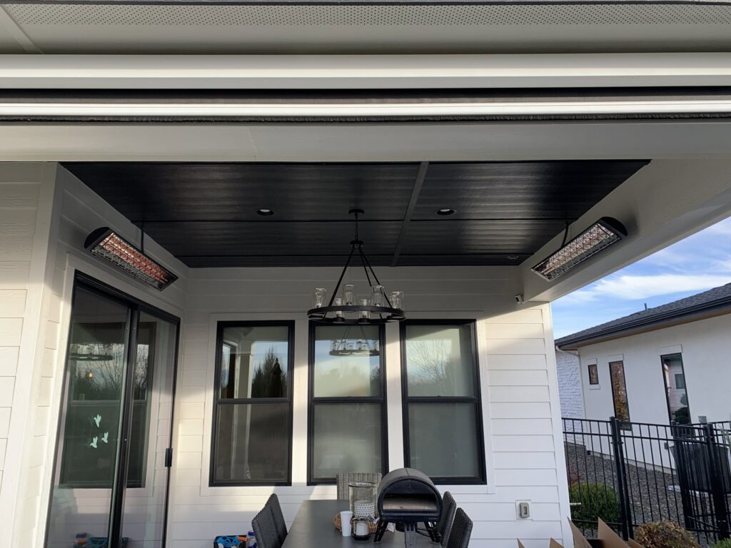 Outdoor patio with newly installed overhead heaters and a chandelier by All 4 You Electrical in Boise, ID.