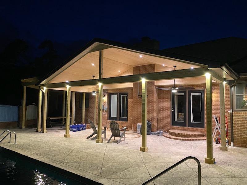 Outdoor patio with installed recessed lighting and ceiling fans at night by Top Tier Electrical Services LLC in Knoxville, TN
