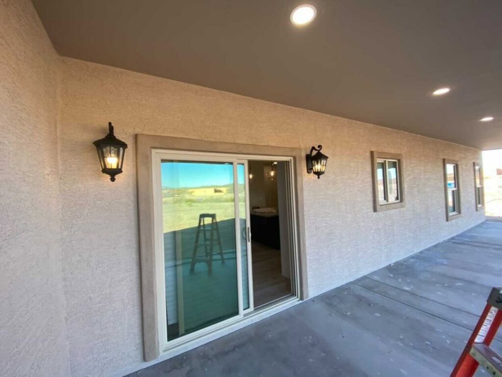 Outdoor patio with newly installed wall lanterns and recessed lighting by Pro Solutions Electric in Glendale, AZ.