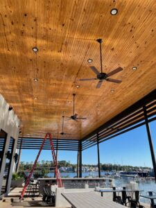 An outdoor patio featuring newly installed recessed lighting and ceiling fans by LOJ Electric, LLC in Houston, TX.