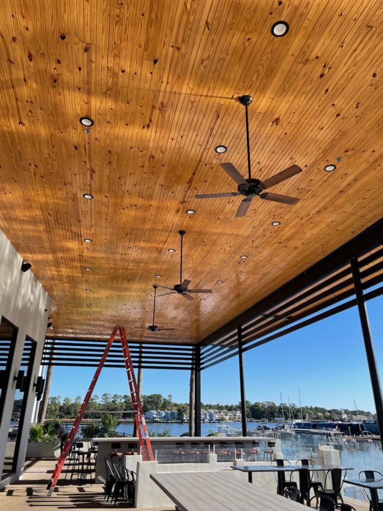 An outdoor patio featuring newly installed recessed lighting and ceiling fans by LOJ Electric, LLC in Houston, TX.