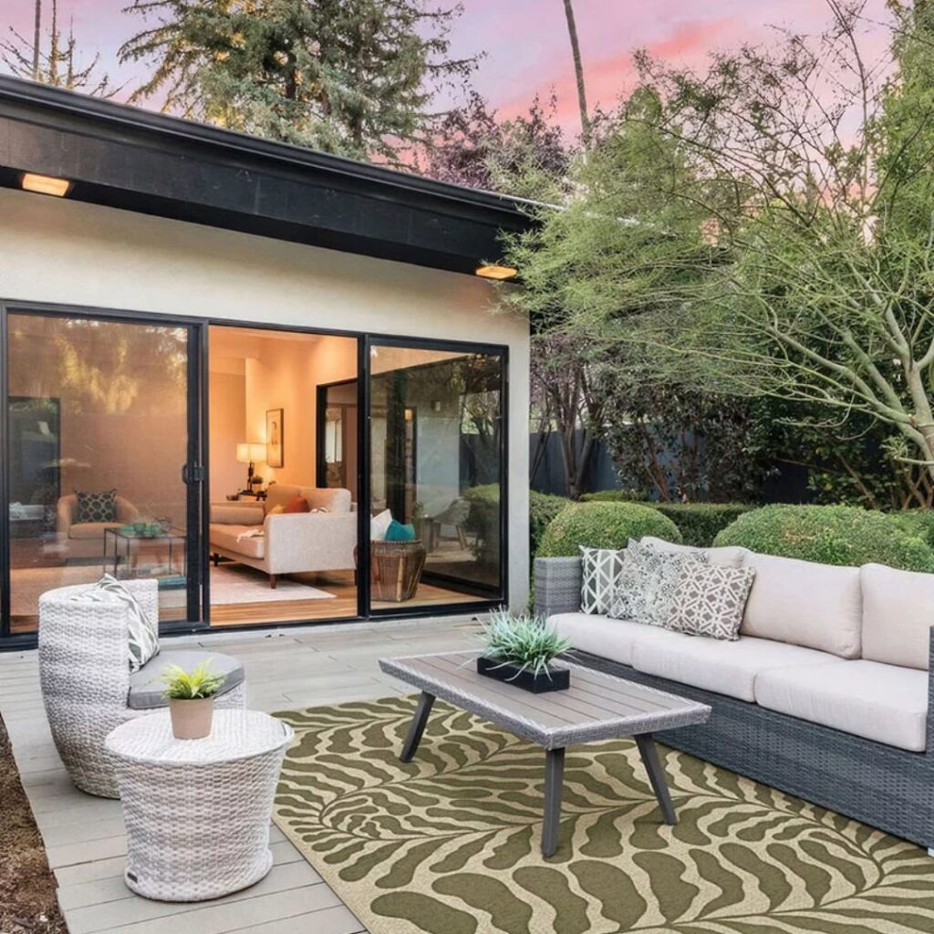 An inviting outdoor patio featuring a stylish area rug from Morency Flooring in New Bedford, MA.