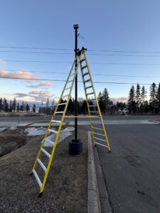 A ladder set up for outdoor pole light or security camera installation by Schroeder Electric in Duluth, MN.