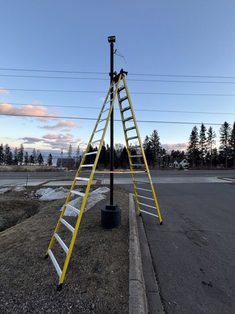 A ladder set up for outdoor pole light or security camera installation by Schroeder Electric in Duluth, MN.