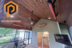 Outdoor screened porch with installed electric heaters, ceiling fan, and lighting by Pinnacle Electric Solutions in Port St. Lucie, FL.