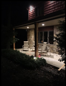 Newly installed outdoor recessed lighting illuminating a porch by John Fean Electrician Inc. in Philadelphia, PA.