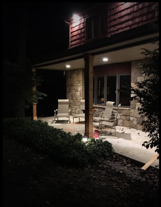 Newly installed outdoor recessed lighting illuminating a porch by John Fean Electrician Inc. in Philadelphia, PA.