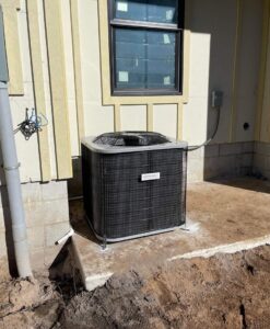 Outdoor residential HVAC condenser unit installed next to a new building by Huggins Mechanical in Jacksonville, FL