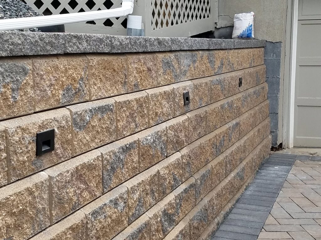 Outdoor retaining wall lighting installation by Julio A Lopez Electrician in Lowell, MA.