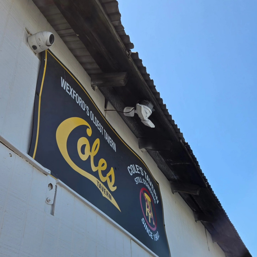 Outdoor security cameras and a light fixture installed on a commercial building by Maiolo Electric in Pittsburgh, PA.