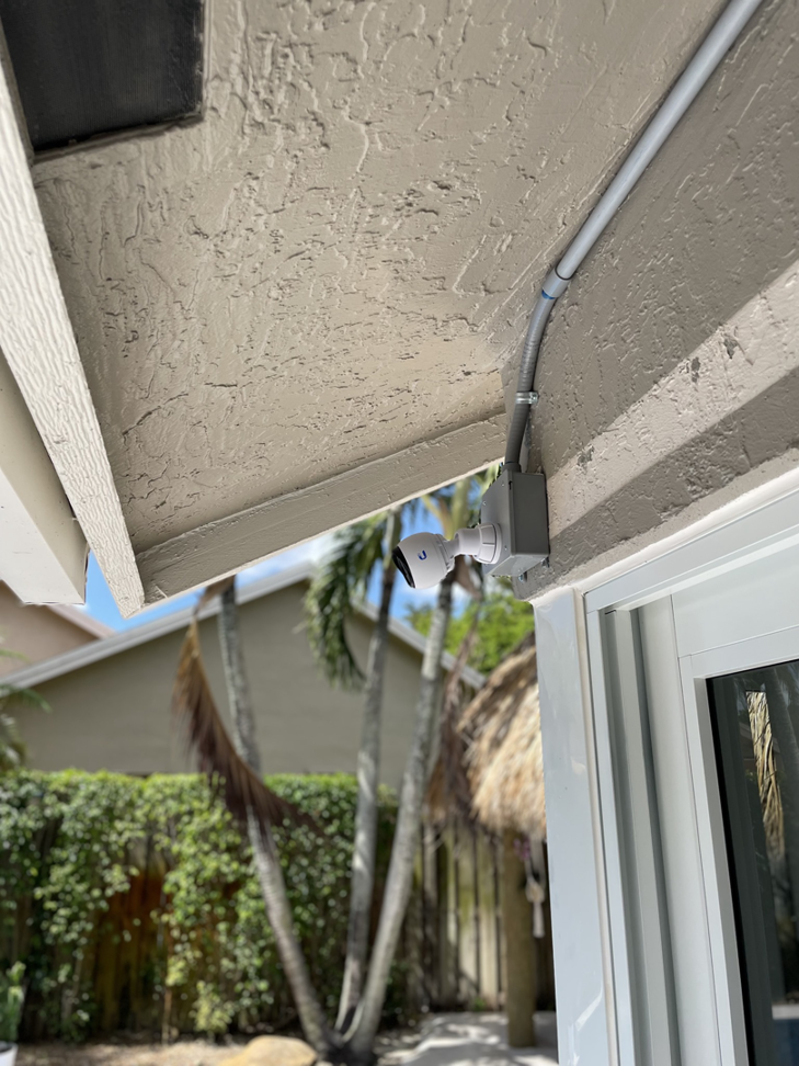 An outdoor security camera installation with electrical conduit by One Installation Inc. in Davie, FL