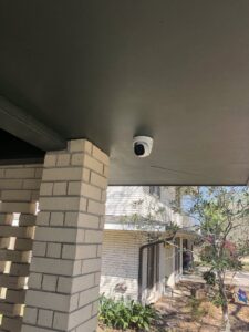 An outdoor security camera mounted under a porch overhang, installed by Greater Baton Rouge Electric in Baton Rouge, LA.