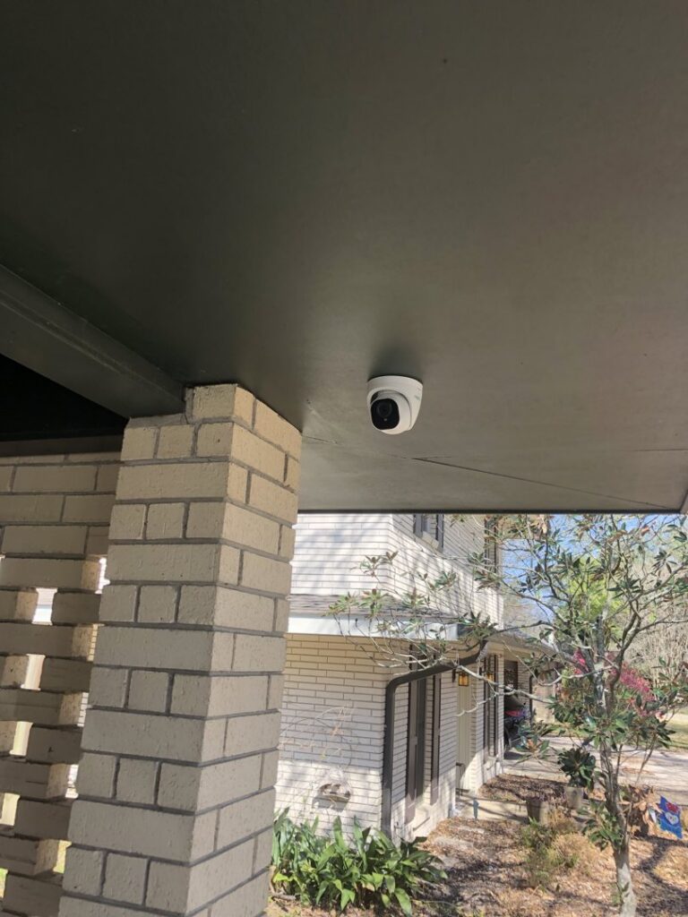 An outdoor security camera mounted under a porch overhang, installed by Greater Baton Rouge Electric in Baton Rouge, LA.