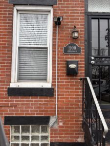 Outdoor security camera and light fixture installation on a brick house by MV Electrical LLC in Phoenix, AZ.