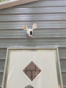 A close-up of an outdoor motion sensor security light and camera installed by Goodie's Electrical Contractors LLC in Dothan, AL