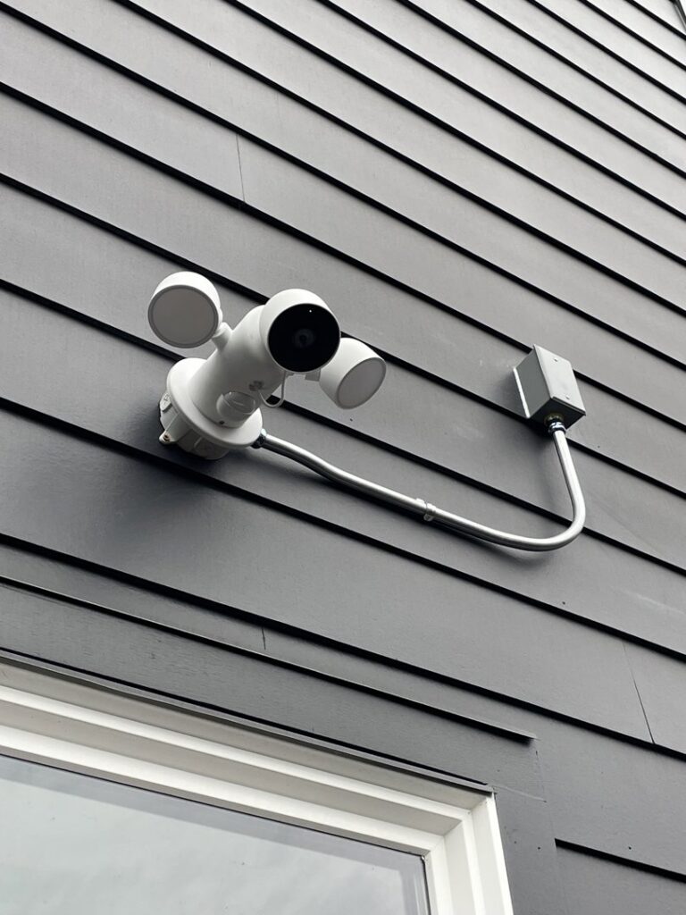 An outdoor security light and camera system with conduit installed by Delatour Electric in Portland, OR.