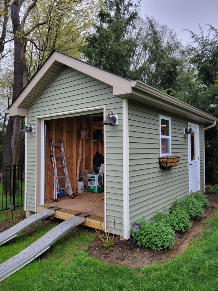 Exterior lighting fixtures installed on an outdoor shed, showcasing work by Maiolo Electric in Pittsburgh, PA.
