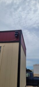 An outdoor siren or speaker system mounted on the corner of a commercial building by KS Retail Solutions in Victoria, TX