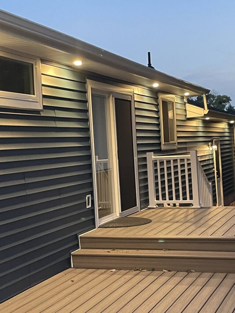 Outdoor soffit and deck lighting installed on the exterior of a house by E & E Electric in Post Falls, ID.