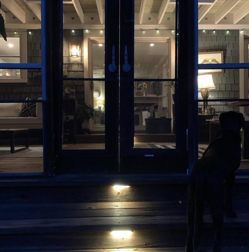 Outdoor step lighting illuminating a deck at night, installed by Harbour Electric in Wilmington, NC.