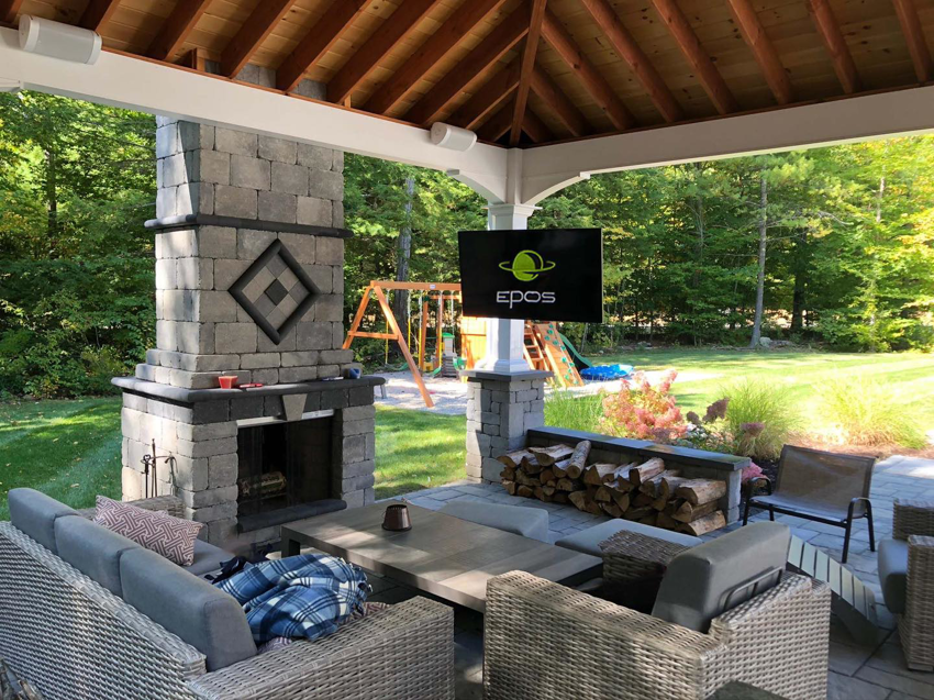 An outdoor TV and ceiling speakers installed on a patio by EPOS Systems, Inc. in West Springfield, MA.